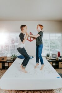 family mental health a boy and girl tween jumping on a bed