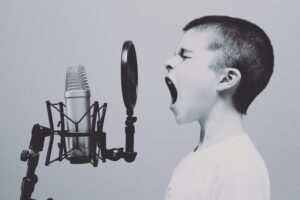 how to start a child in acting kid yelling into microphone