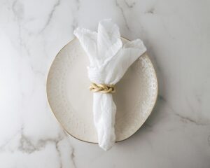 white napkin on white plate how and why to switch from paper napkins to cloth